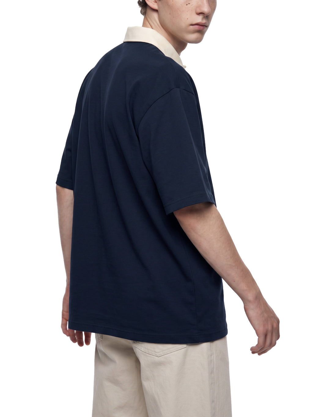 Off Script Unisex Color Block Polo Shirt on male model back three-quarter view