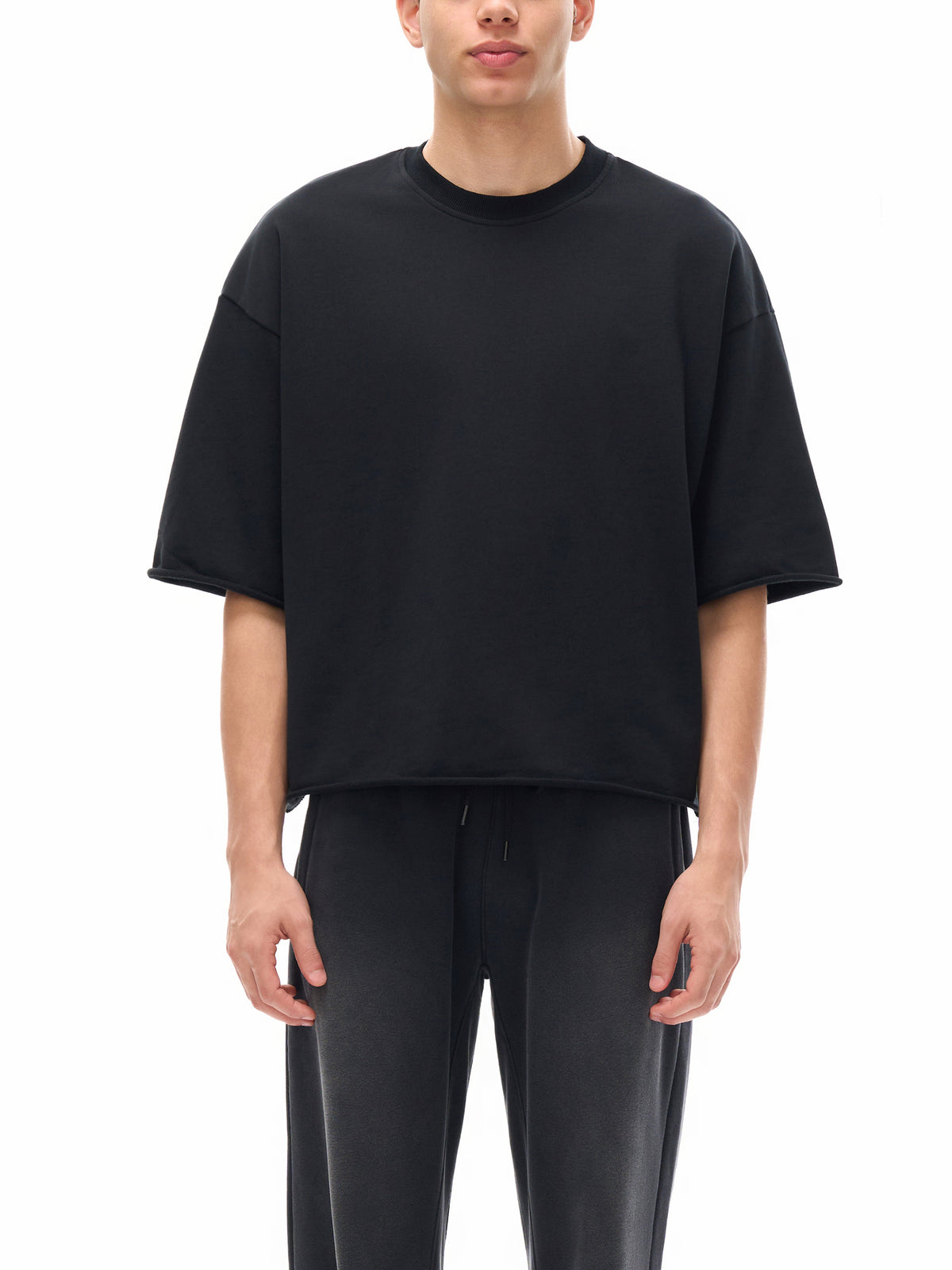 Unisex French Terry Raw-Edge T-Shirt in Black - model front view