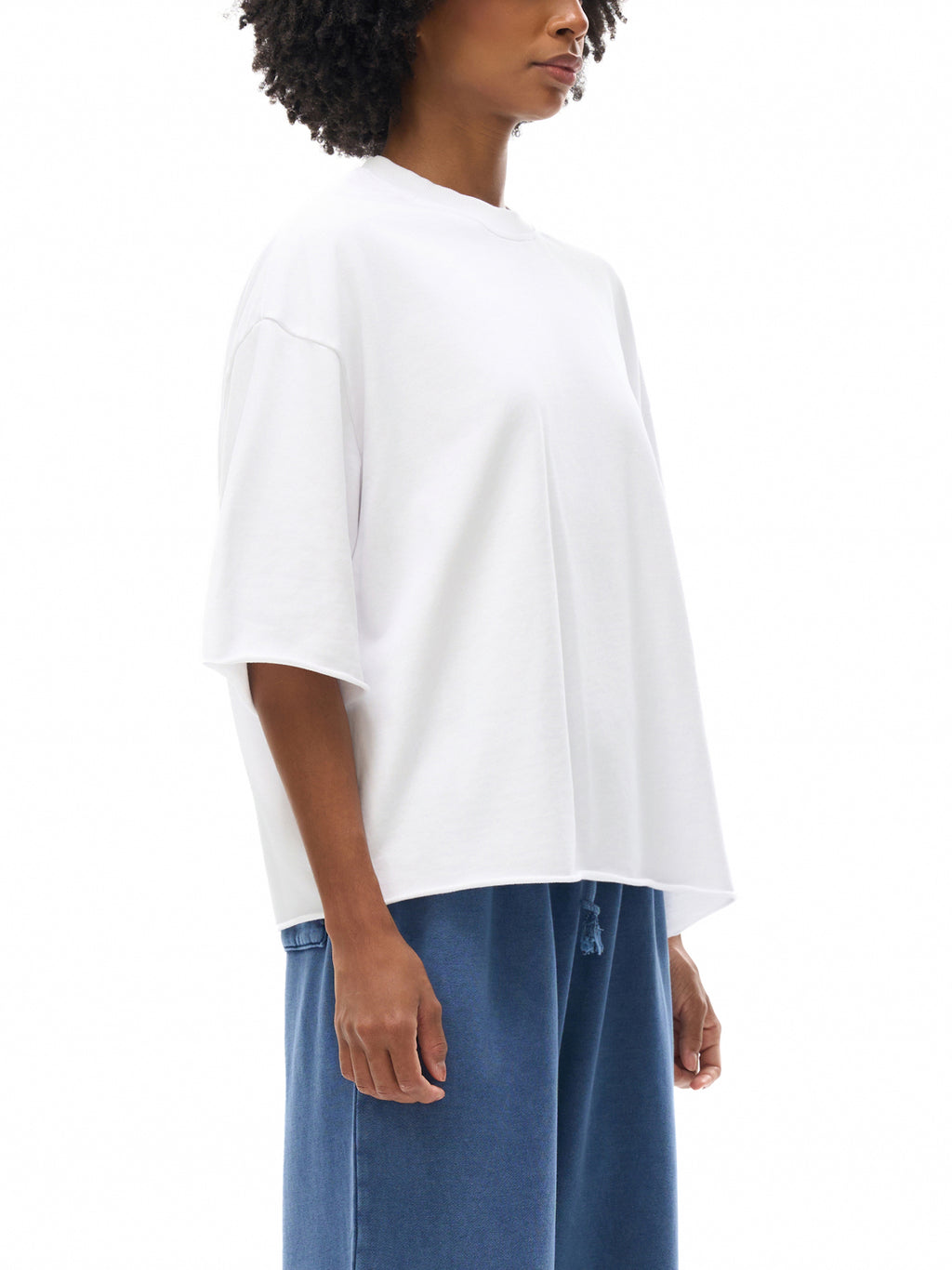 Unisex French Terry Raw-Edge T-Shirt in White - model side view